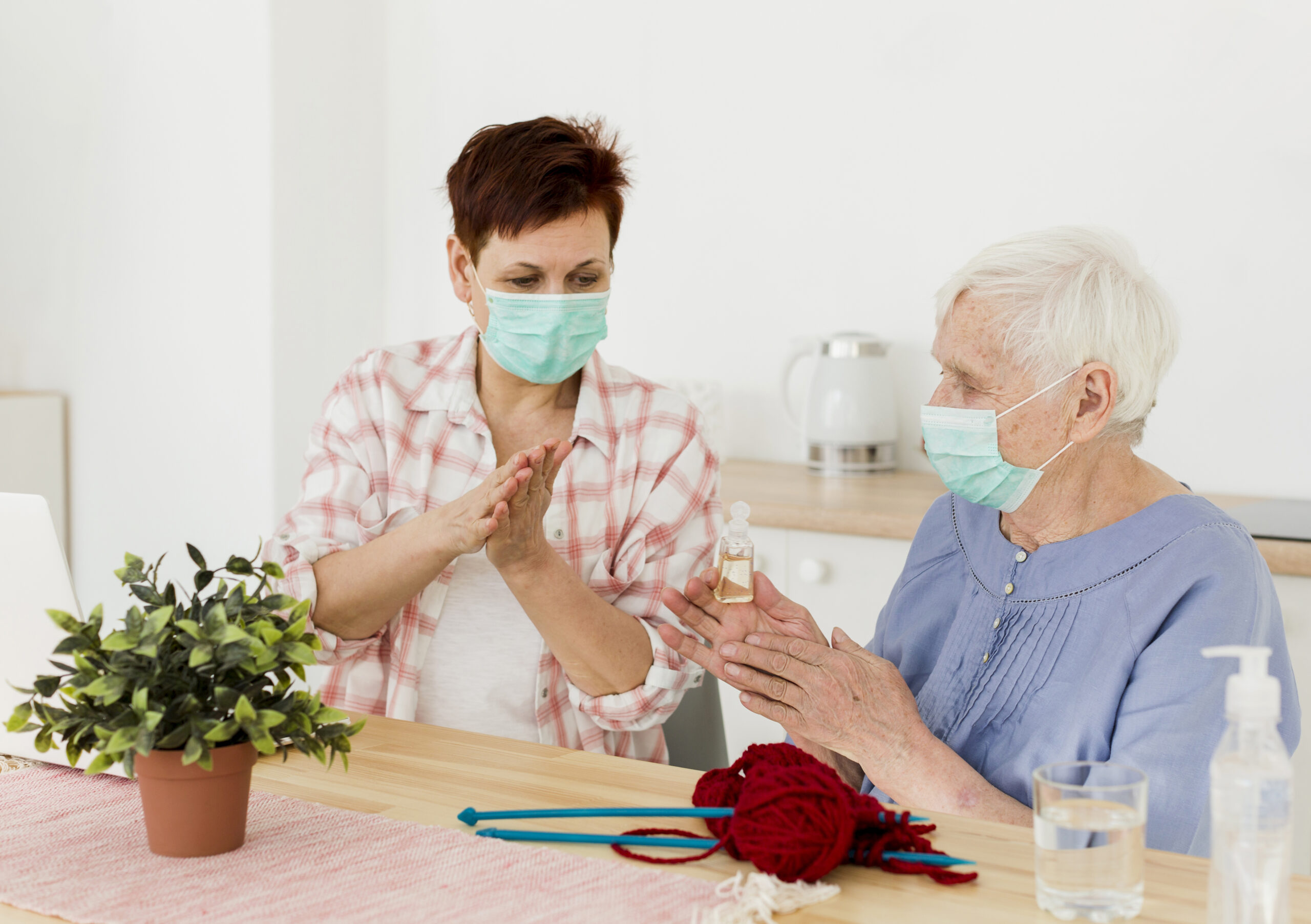 elder women disinfecting their hands while home