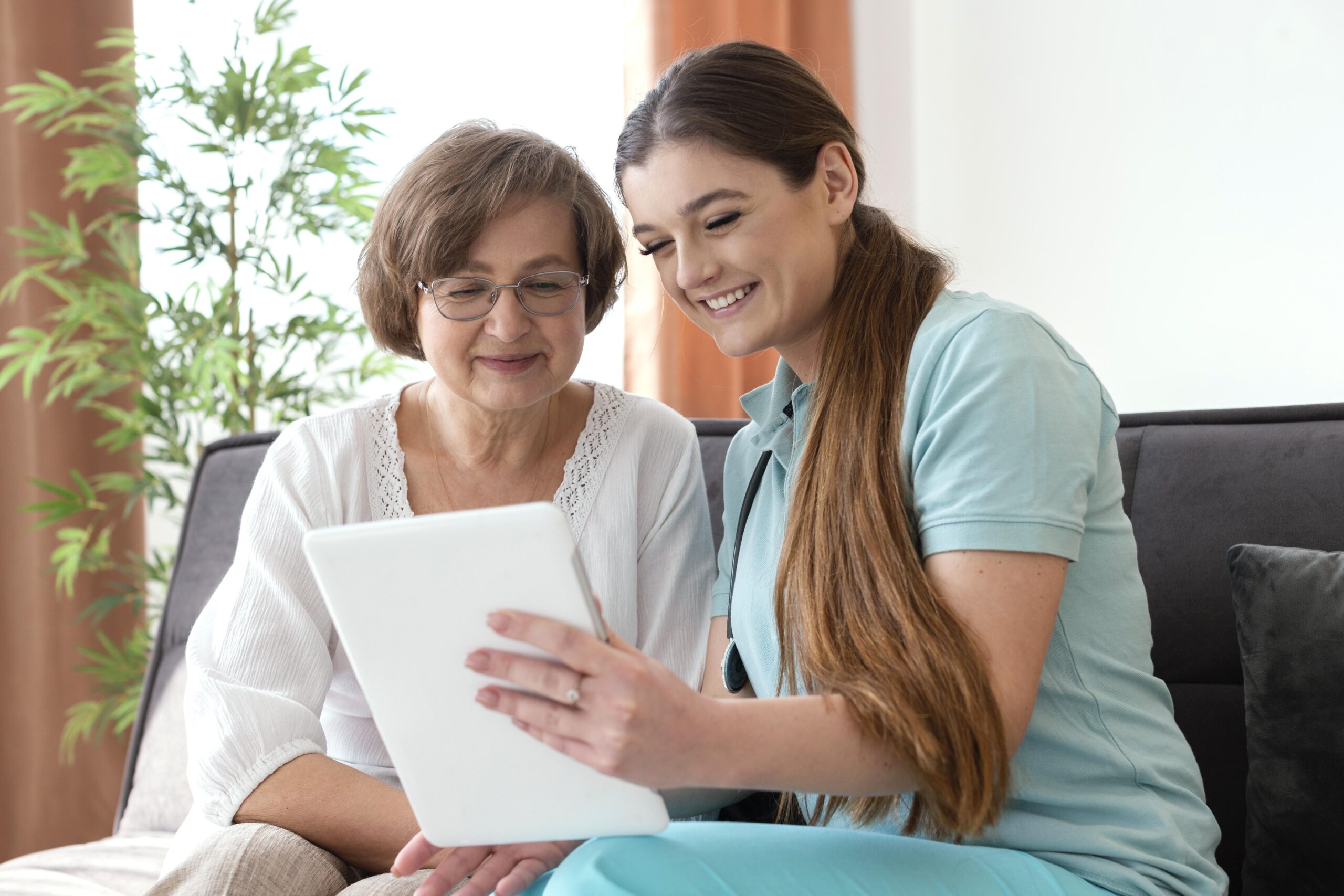 medium shot smiley women looking tablet