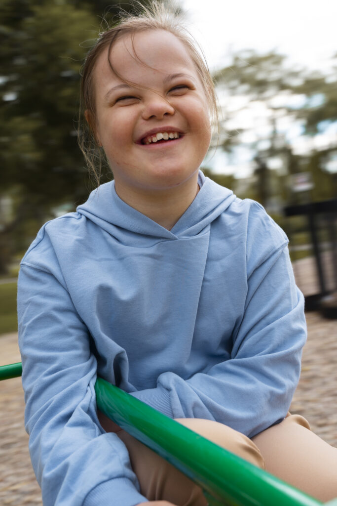 Rebuilding Bonds happy child with down syndrome playing outside
